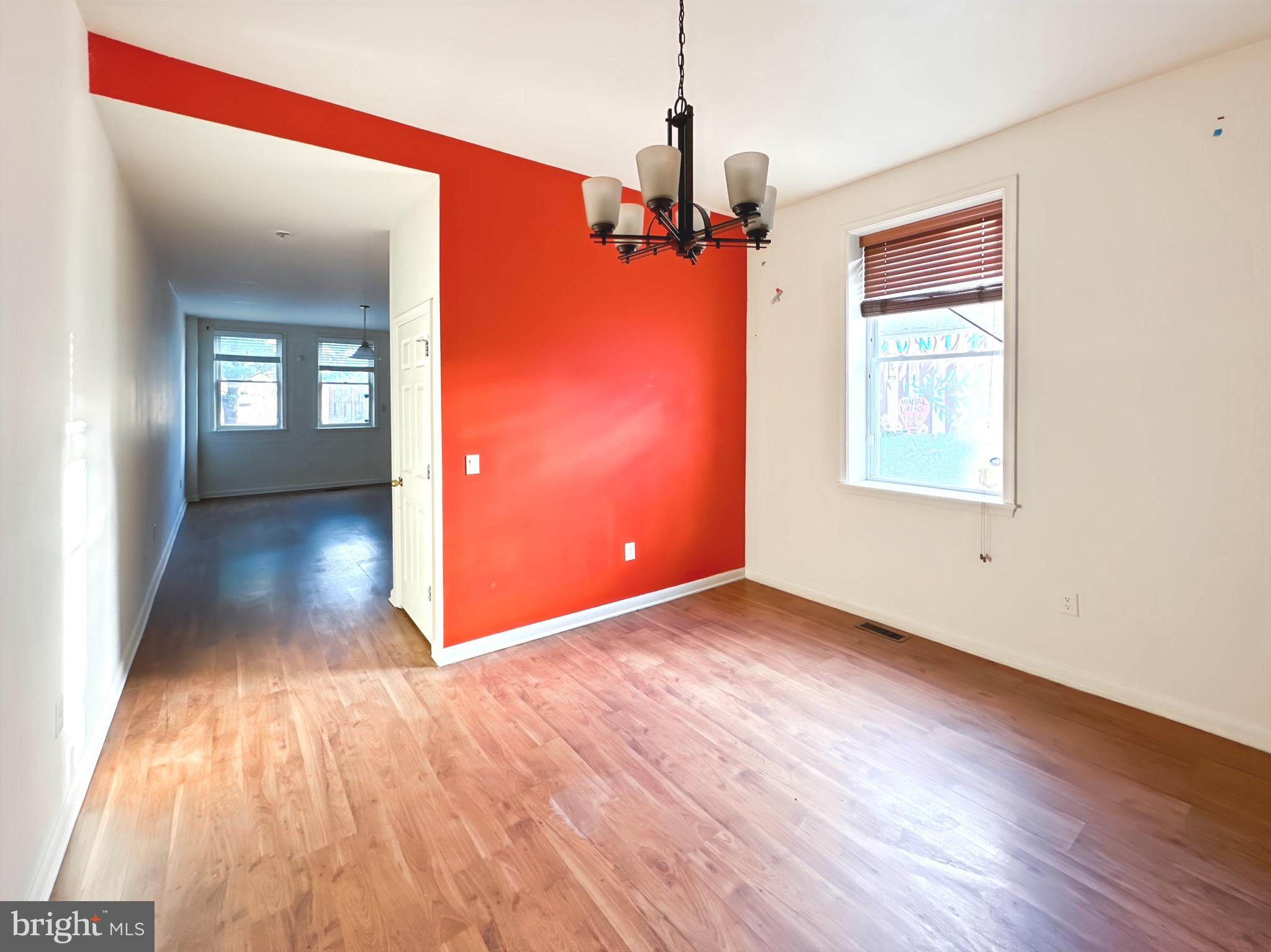2426 Jefferson Street Baltimore, MD 21205 - Photo 4 of 17 a view of a hallway with wooden floor and a living room