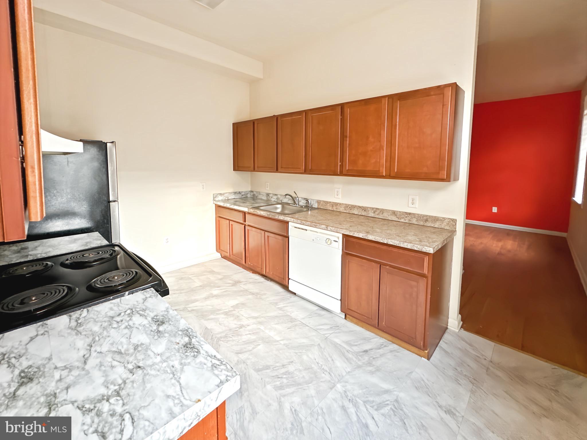 2426 Jefferson Street Baltimore, MD 21205 - Photo 7 of 17 a kitchen with stainless steel appliances granite countertop a stove a sink and a refrigerator
