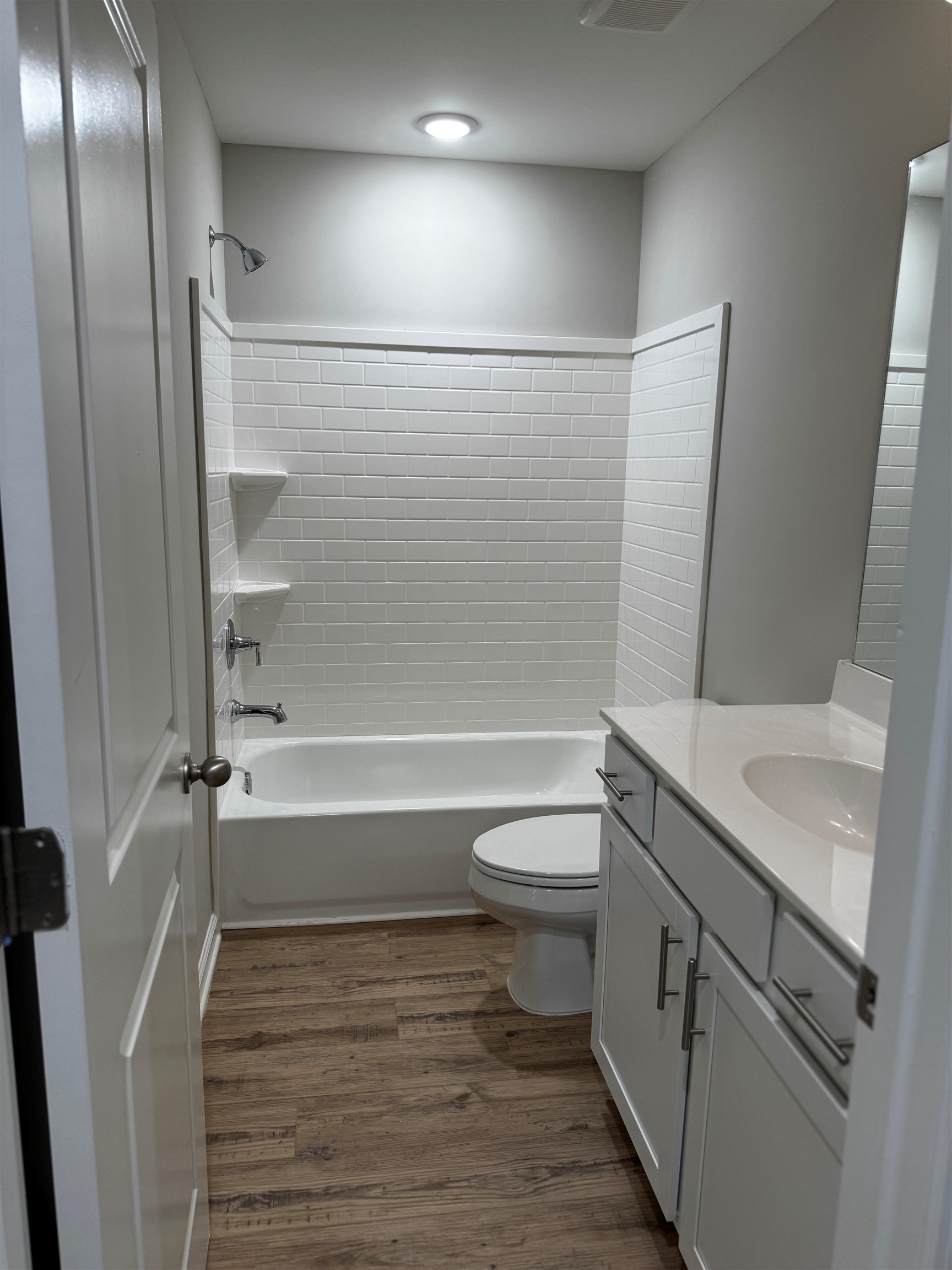 5283 Zodiac Road Memphis, TN 38118 - Photo 5 of 13 Bathroom featuring a tub/shower combination with white subway tile surround and integrated shelving