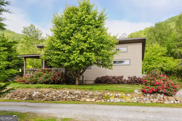 a front view of a house with a garden