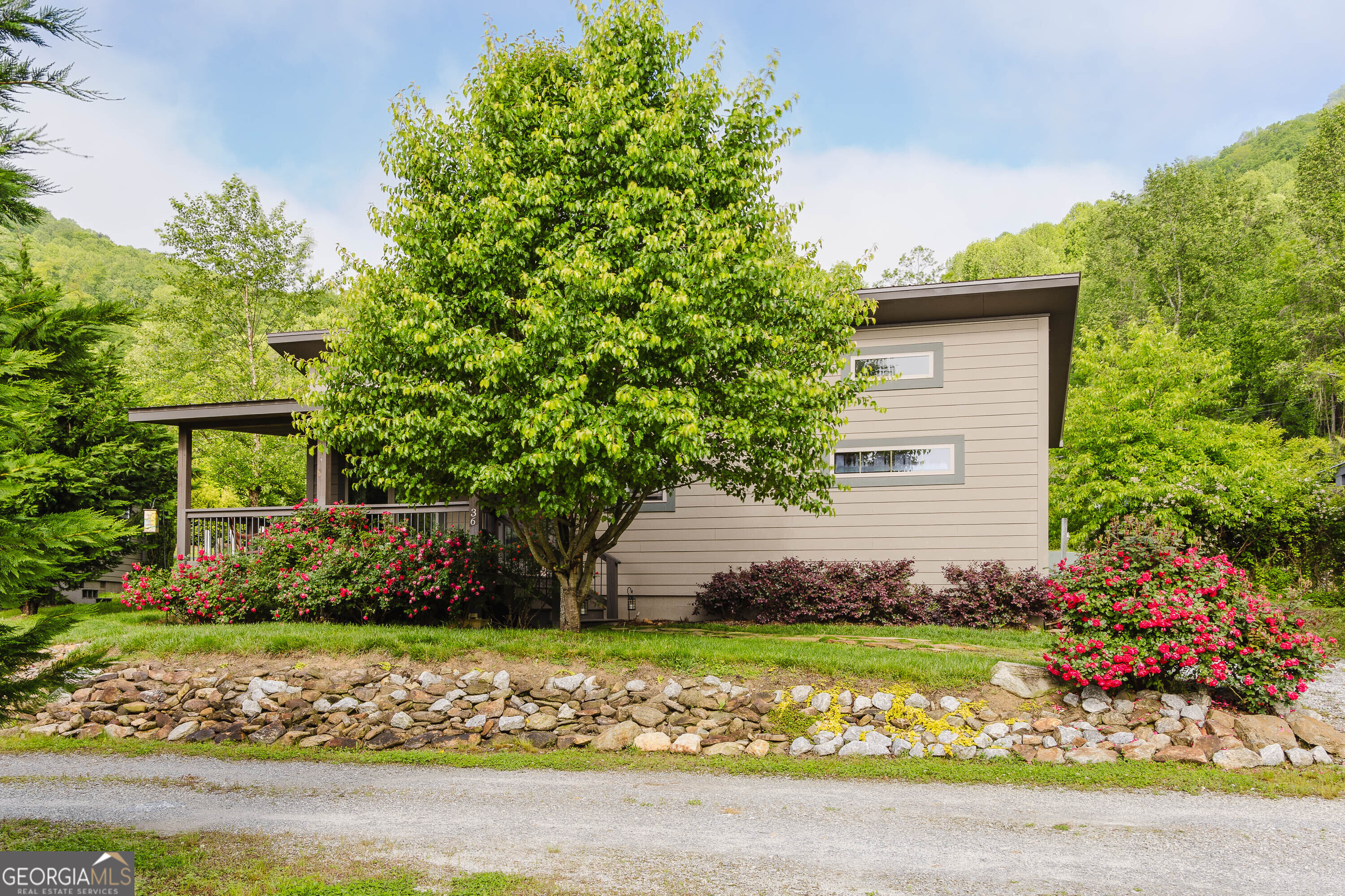 36 Maple Springs Lane Clayton, GA 30525 - Photo 19 of 26 a front view of a house with a garden