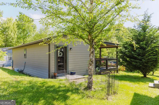 a view of a house with pool and sitting area