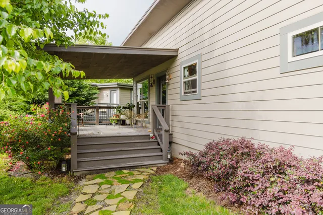 a view of house with backyard and sitting area