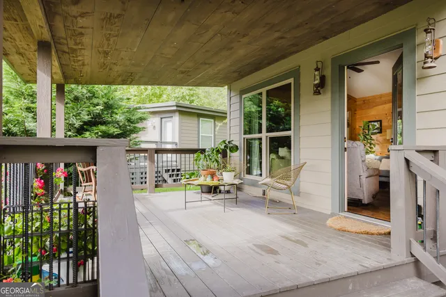 a living room filled with furniture and a potted plant