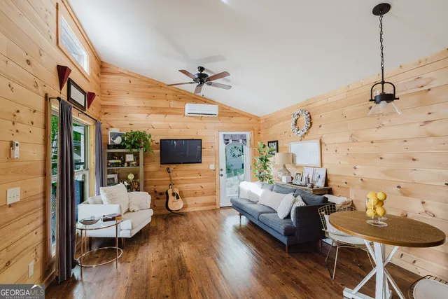 a living room with furniture and a flat screen tv