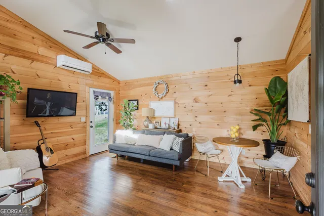 a living room with furniture and a flat screen tv
