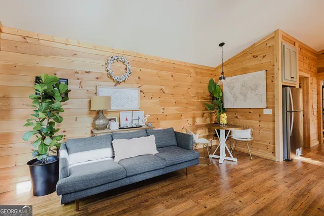 a living room with furniture and a potted plant