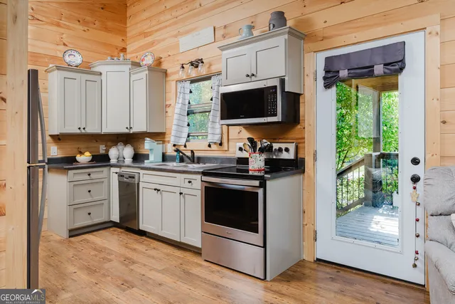 a kitchen with stainless steel appliances granite countertop a stove a sink and a refrigerator