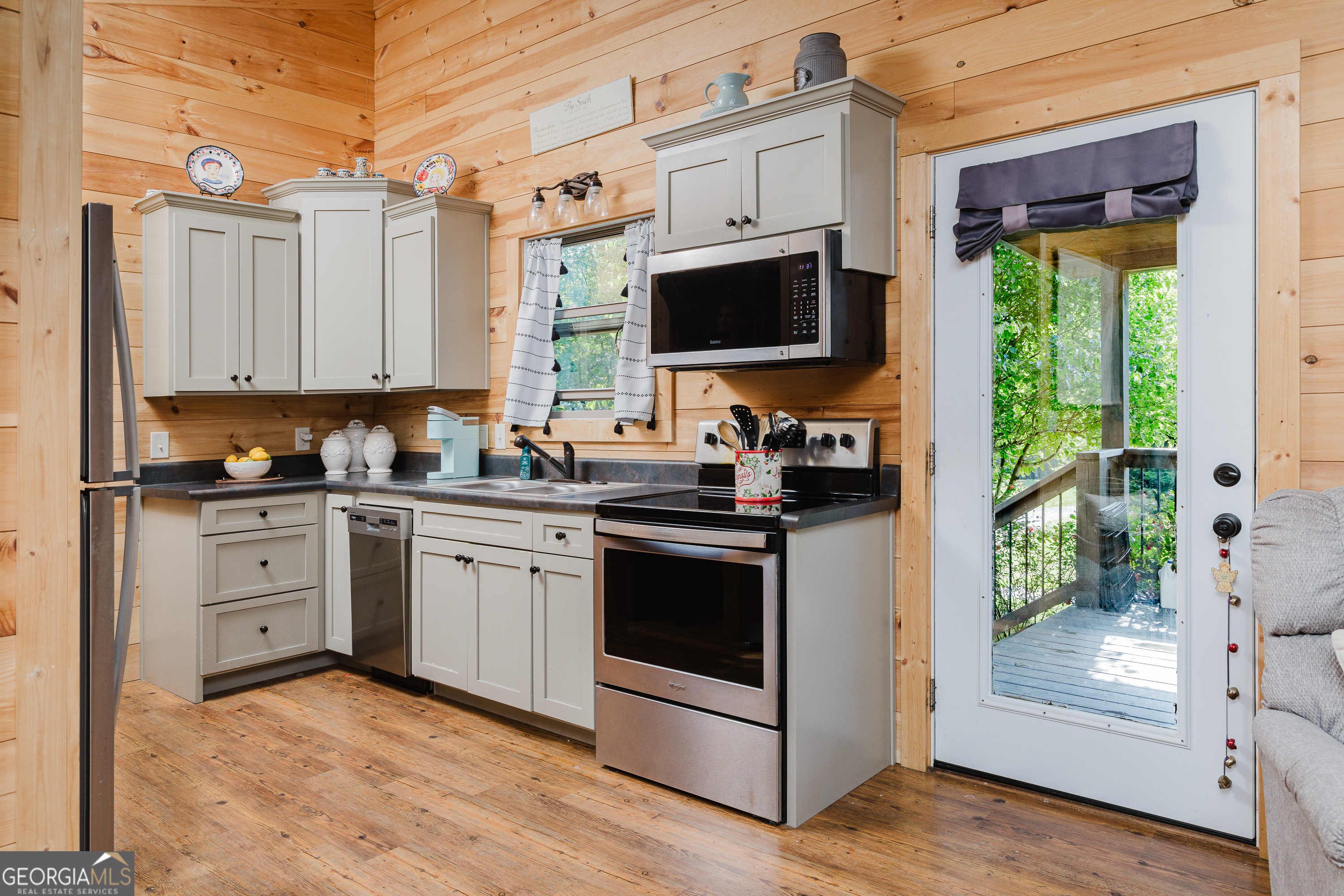 36 Maple Springs Lane Clayton, GA 30525 - Photo 9 of 26 a kitchen with stainless steel appliances granite countertop a stove a sink and a refrigerator