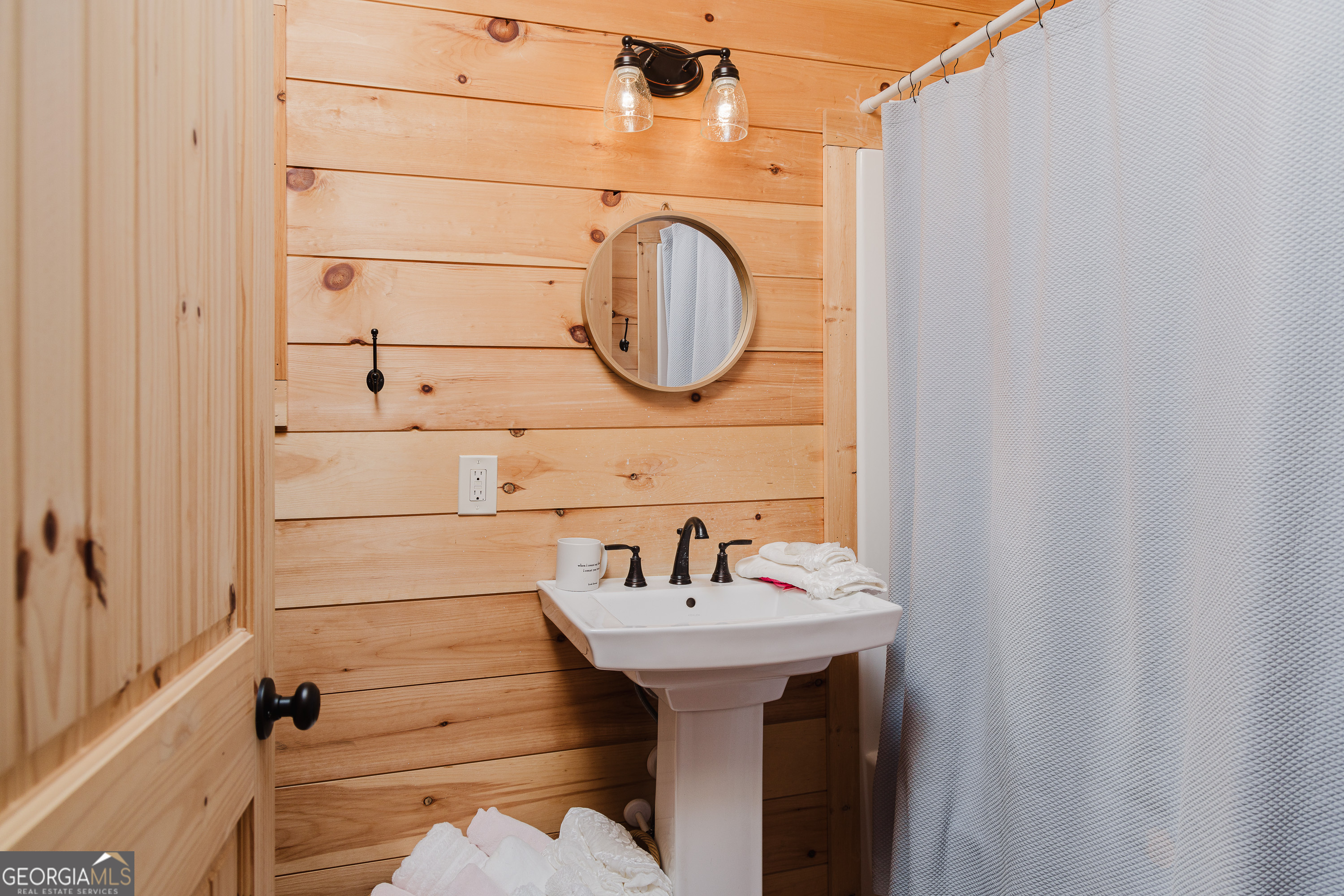 36 Maple Springs Lane Clayton, GA 30525 - Photo 10 of 26 a bathroom with a sink and a mirror