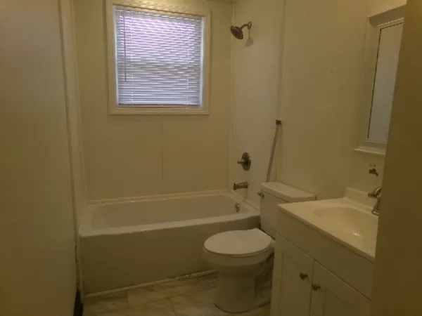 a bathroom with a toilet a sink and bathtub