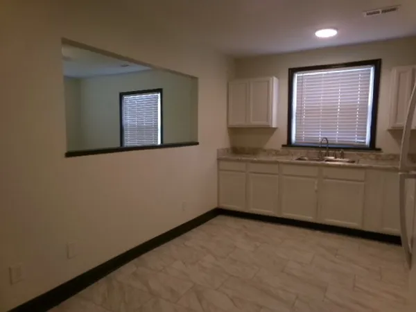 a view of kitchen with stainless steel appliances cabinets