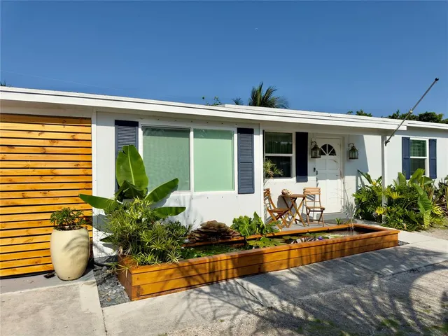 a front view of a house with swimming pool and porch