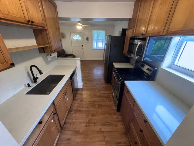 a kitchen with sink cabinets and appliances