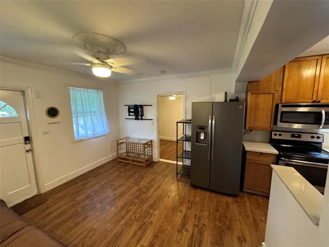 a kitchen with stainless steel appliances granite countertop a refrigerator stove and microwave