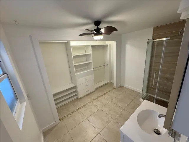 a bathroom with a double vanity sink toilet and shower