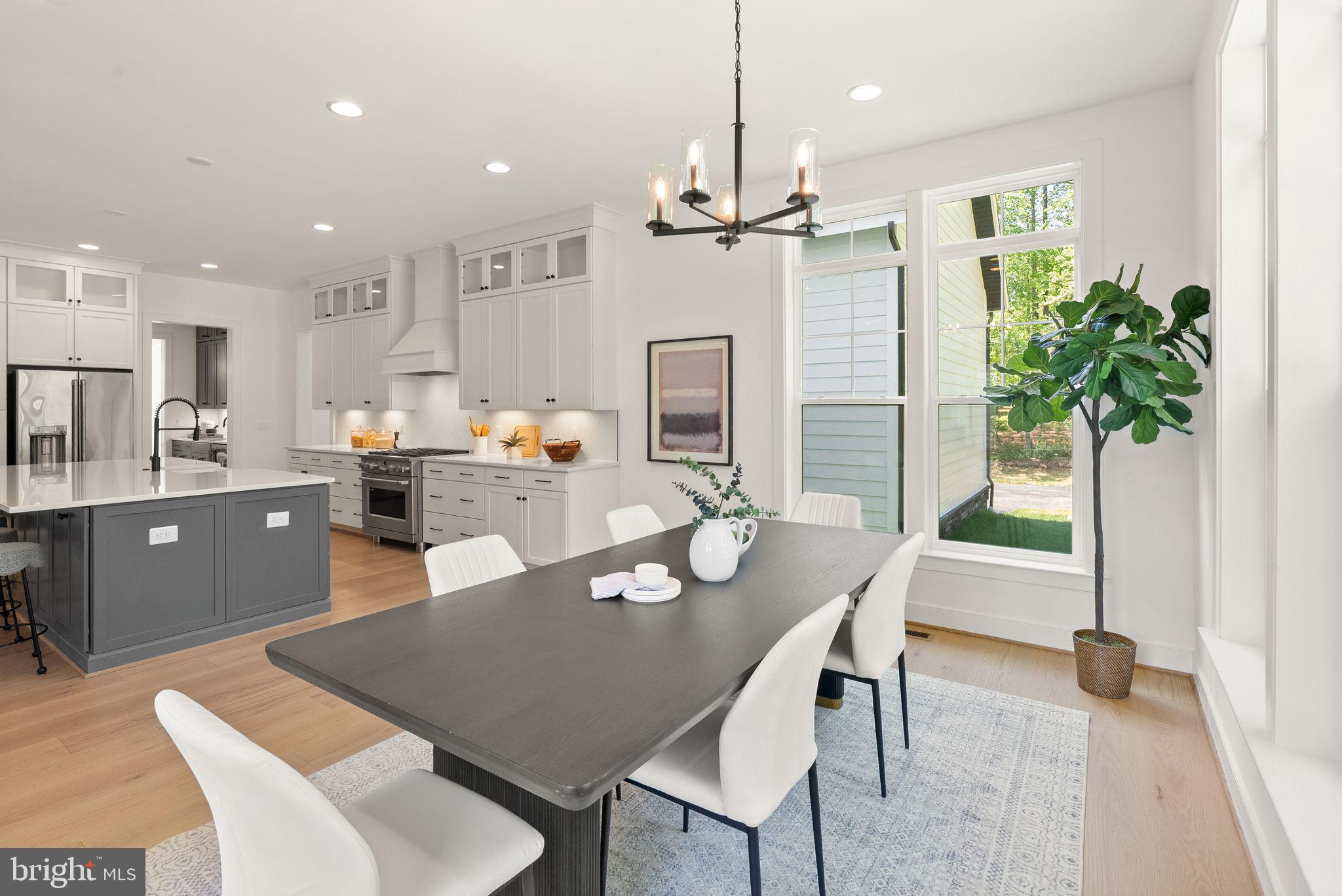 7207 Barnett Road Bethesda, MD 20817 - Photo 15 of 27 a dining room with furniture a chandelier and kitchen view