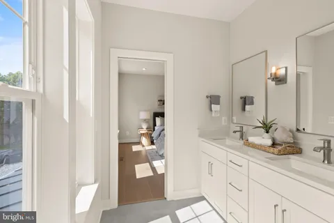 a bathroom with a double vanity sink and a mirror