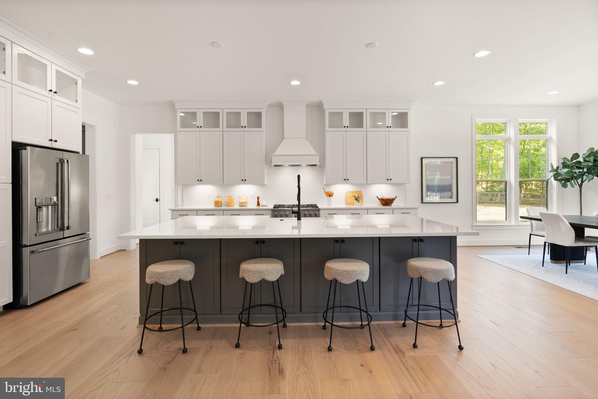 7207 Barnett Road Bethesda, MD 20817 - Photo 22 of 27 a kitchen with granite countertop a sink and chairs