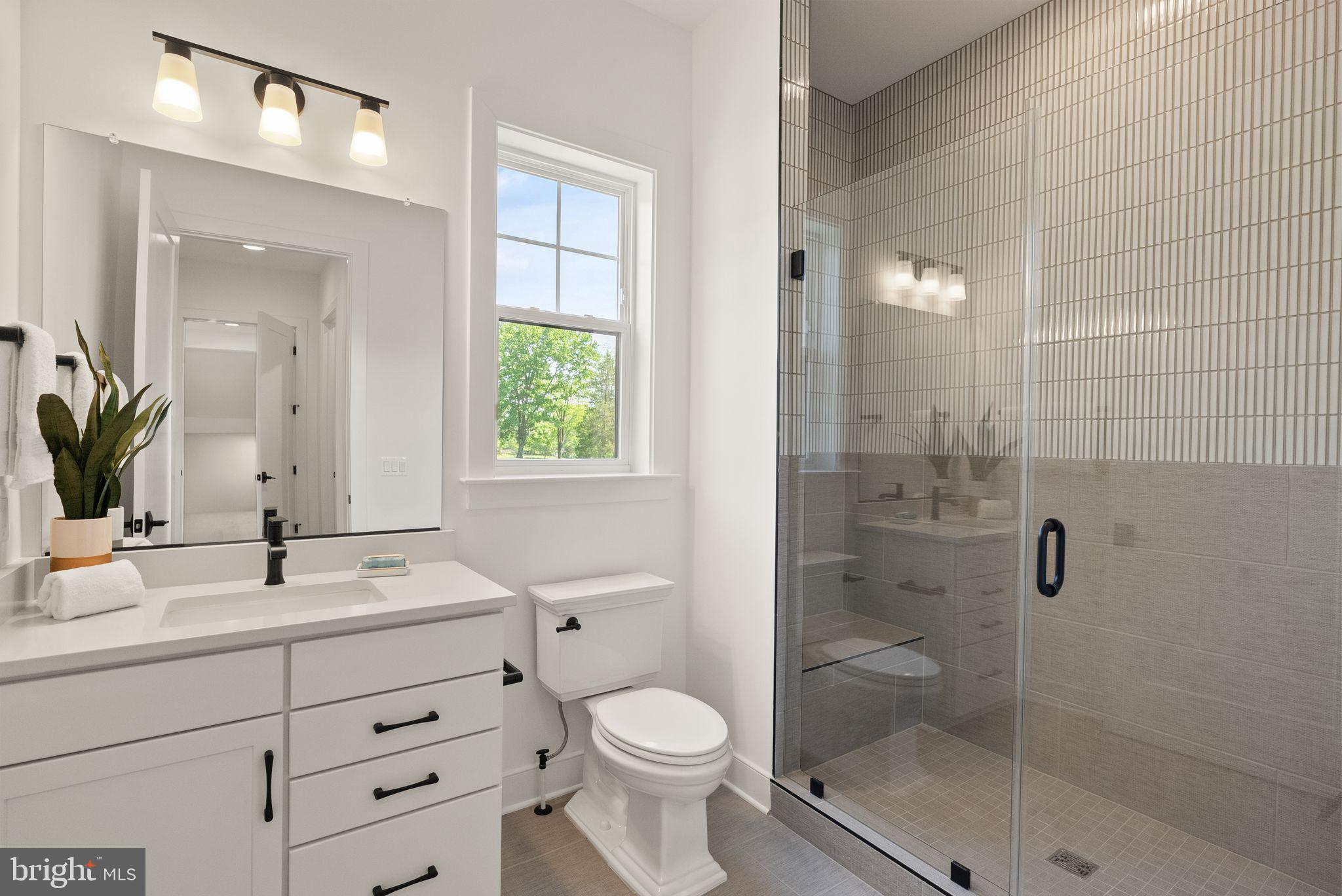 7207 Barnett Road Bethesda, MD 20817 - Photo 26 of 27 a bathroom with a granite countertop toilet sink shower and mirror