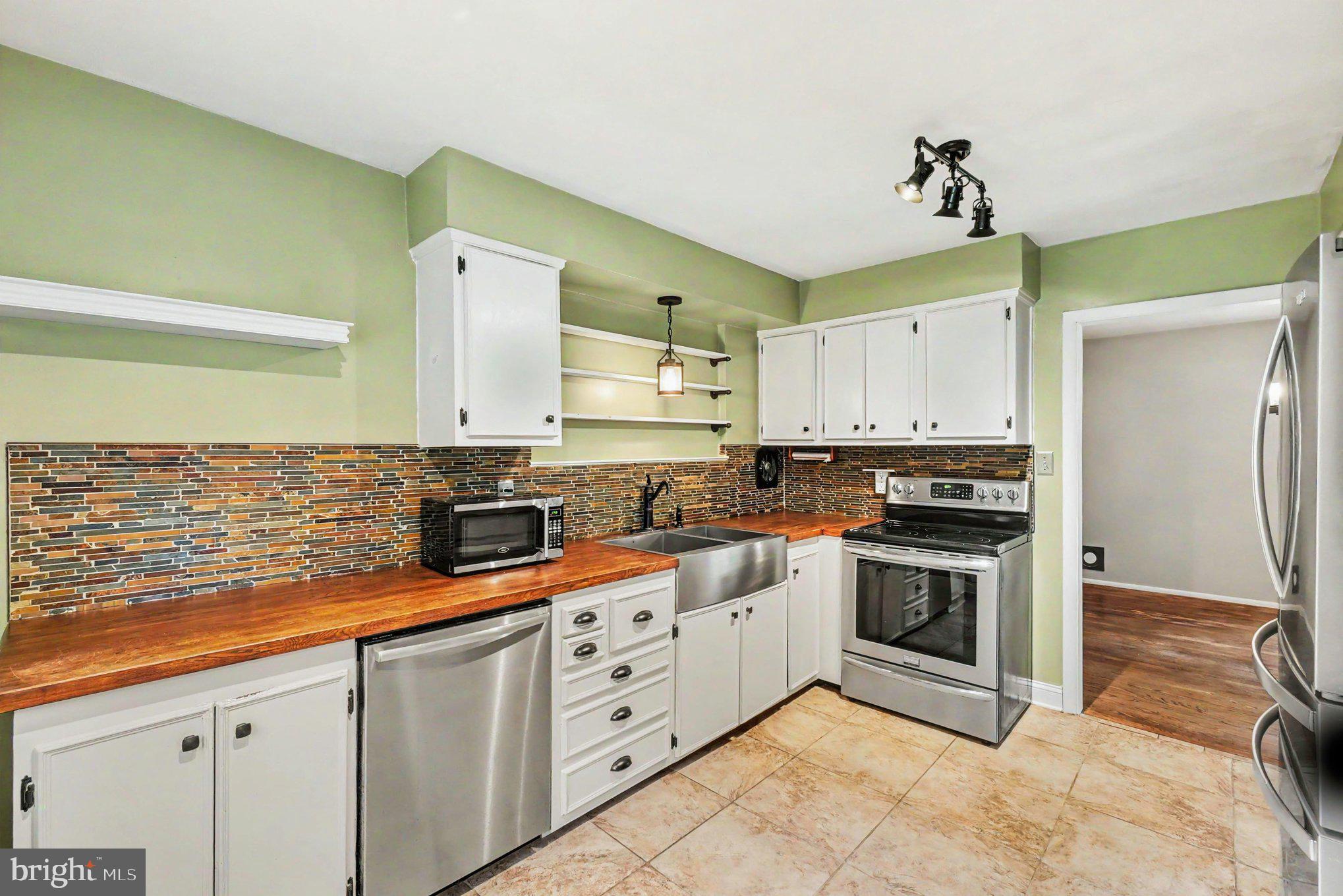 201 Mountain Road Fallston, MD 21047 - Photo 12 of 35 a kitchen with stainless steel appliances granite countertop a sink and a stove