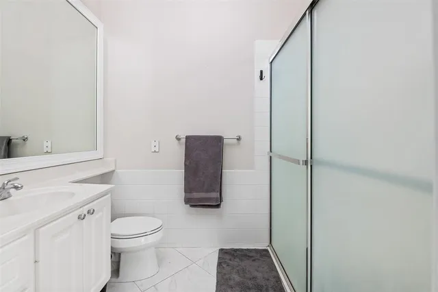 a white toilet sitting next to a bathroom sink