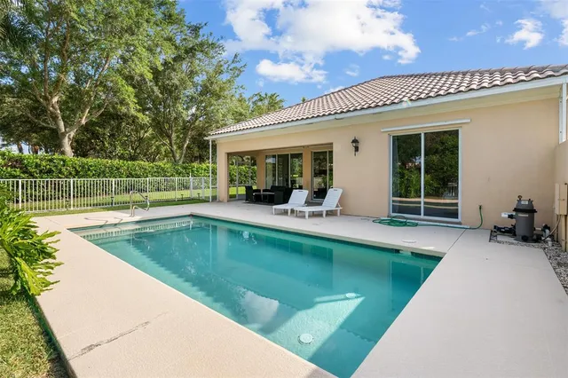 a view of a house with a backyard porch and sitting area
