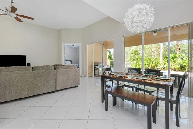 a view of a dining room and livingroom with furniture window and outside view