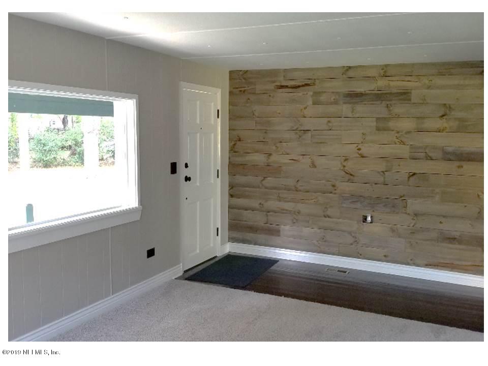 5209 Yellow Water Road Jacksonville, FL 32234 - Photo 3 of 25 Foyer with wood wall entrance