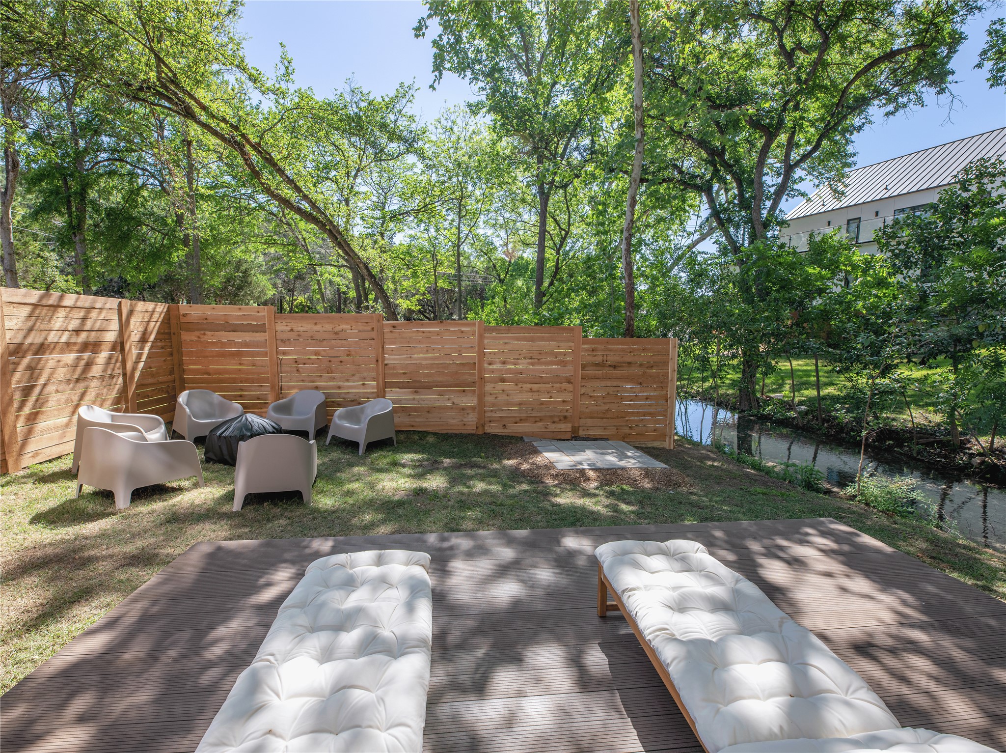 2806 Geronimo Trail Austin, TX 78734 - Photo 31 of 36 a view of a backyard with table and chairs potted plants and large trees