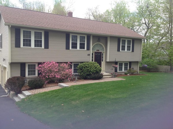 65 Prescott Street Rutland, MA 01543 - Photo 2 of 28 a front view of a house with a yard and garage