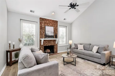 a living room with furniture and a fireplace