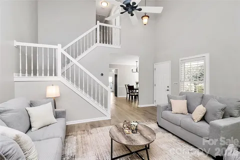 a living room with furniture and a chandelier