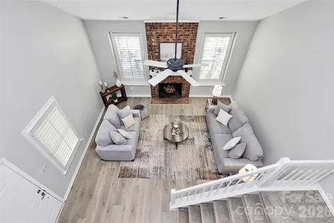 a view of a living room with furniture and a chandelier