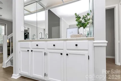 wooden floor with white cabinet