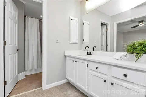 a bathroom with double sink and a mirror