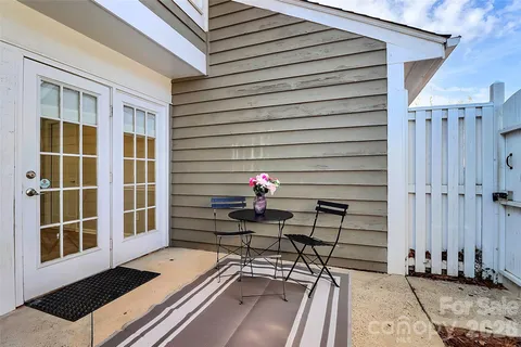 a view of a patio with a table and chairs and wooden floor