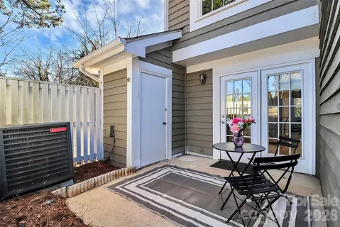 a view of a chairs and tables in the back yard of the house