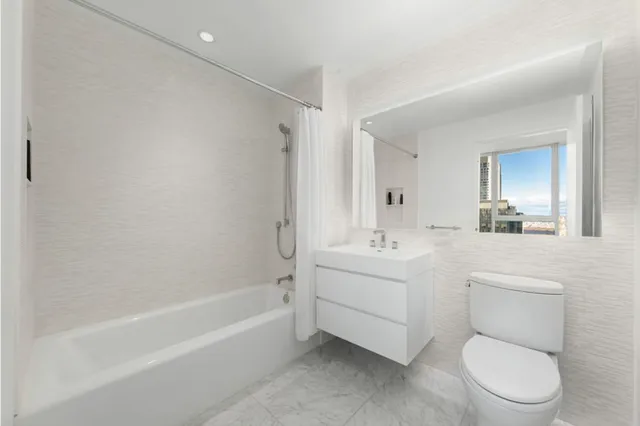 a bathroom with a toilet a sink and a bathtub