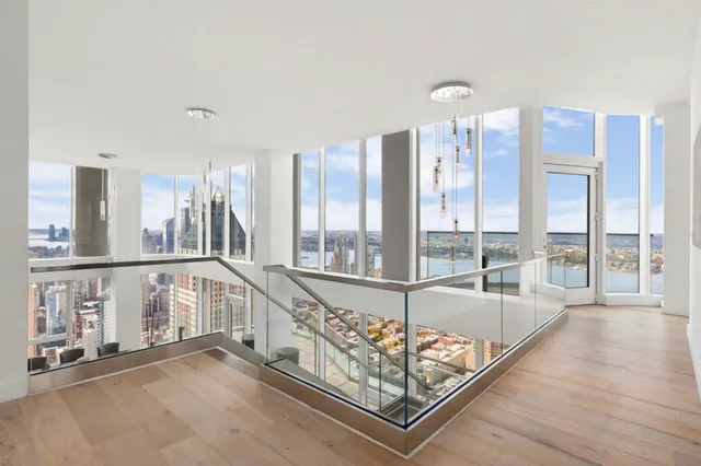 a view of a balcony with furniture and floor to ceiling window