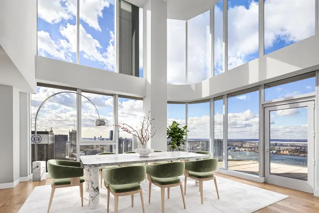 a view of a dining room with furniture large windows and wooden floor