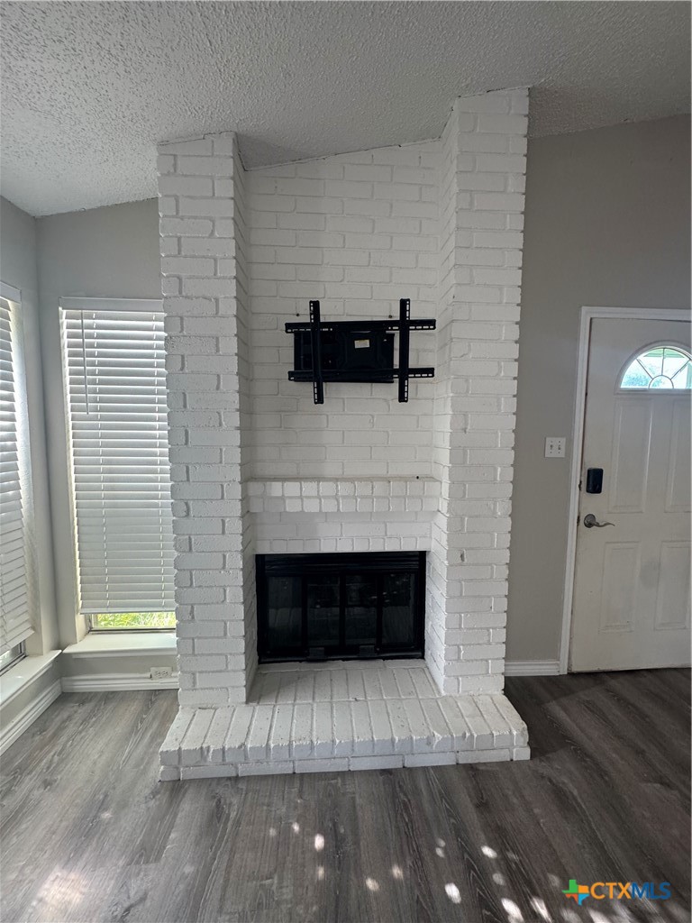 2810 Daniel Boone Trail Temple, TX 76502 - Photo 3 of 18 a living room with a fireplace and wooden floor