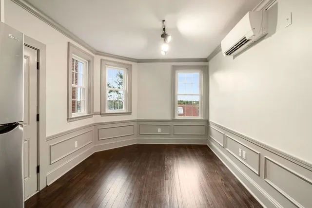 a view of lot with window and wooden floor