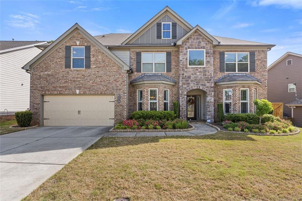 4279 Two Bridge Drive Buford, GA 30518 - Photo 1 of 1 a front view of a house with porch and yard