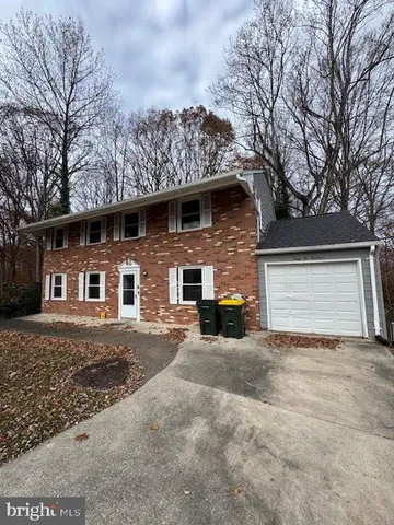 a view of a house with a yard and garage