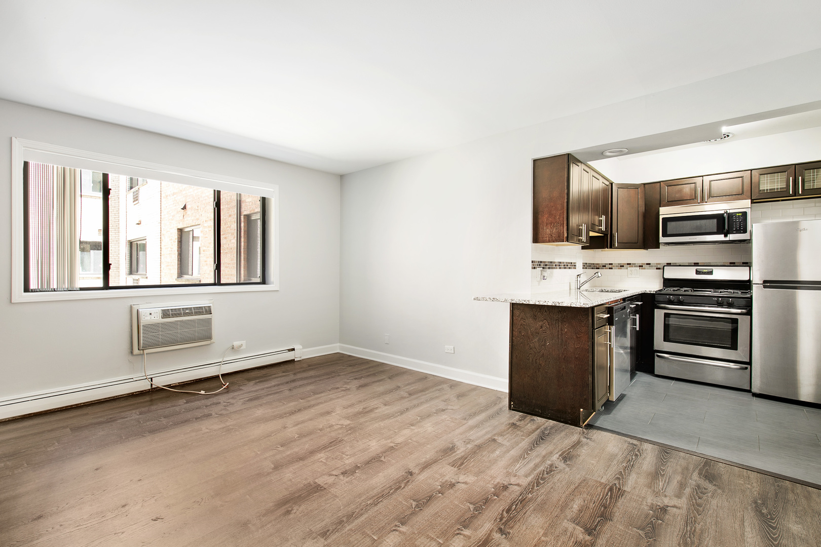 6201 North Kenmore Avenue, Unit 307 Chicago, IL 60660 - Photo 2 of 10 a kitchen with stainless steel appliances a stove and a refrigerator