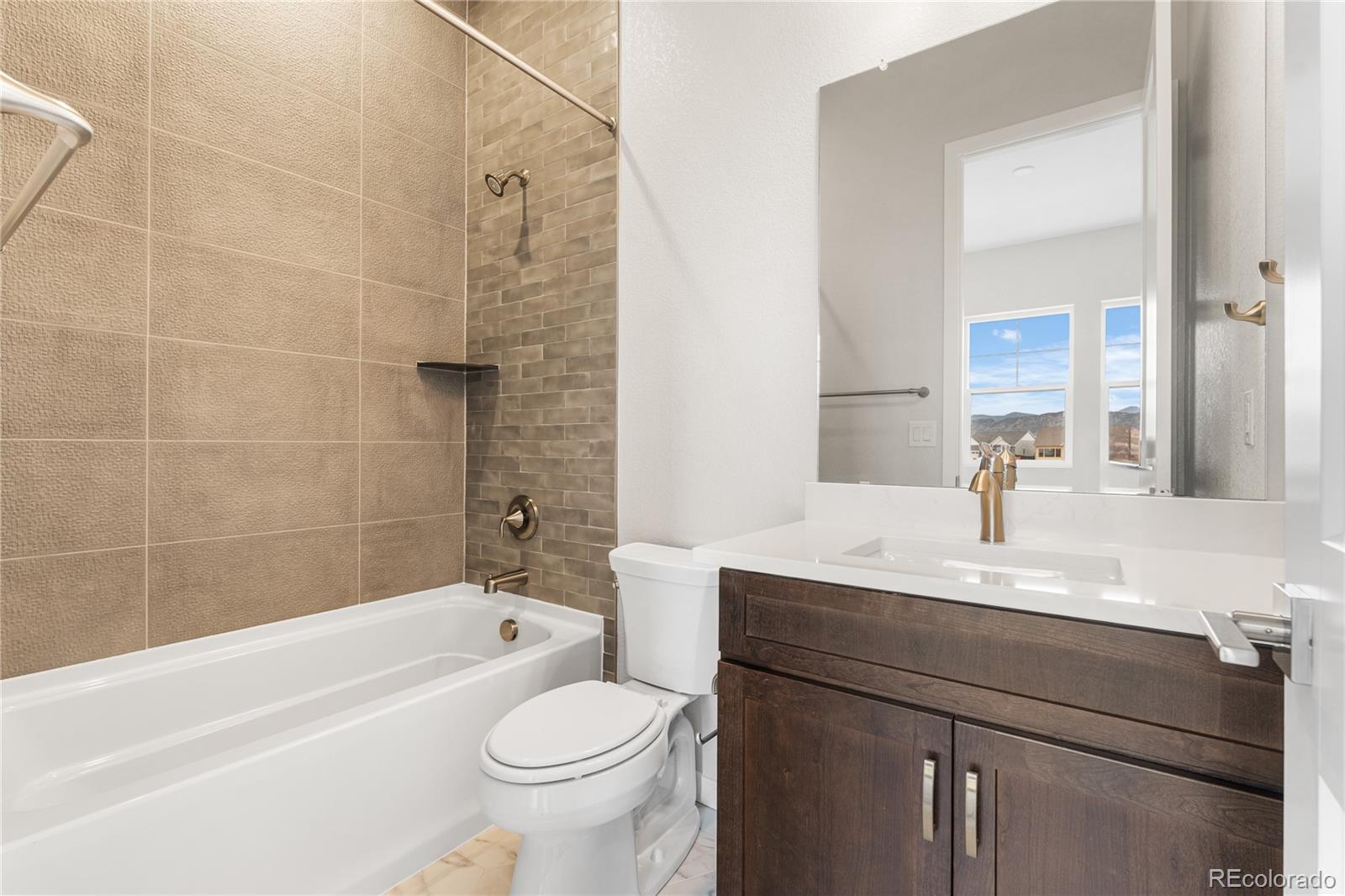 11116 Stonepath Street Littleton, CO 80125 - Photo 24 of 31 a bathroom with a sink a toilet and bathtub
