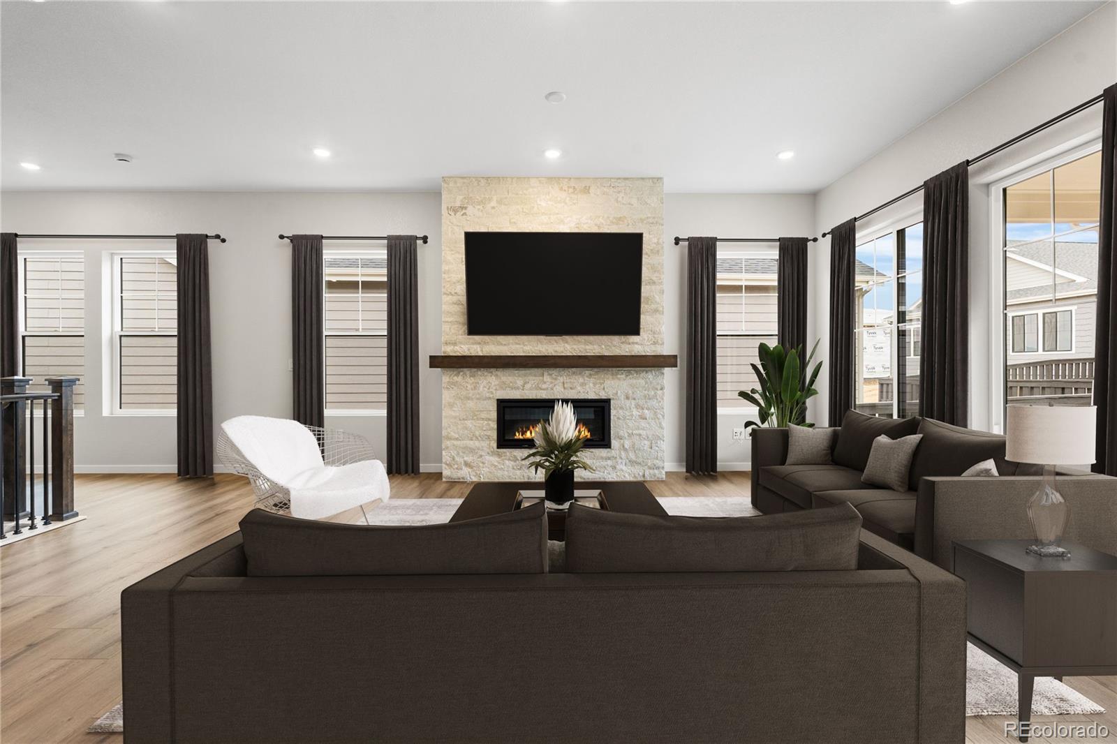 11116 Stonepath Street Littleton, CO 80125 - Photo 10 of 31 a living room with fireplace furniture and a flat screen tv