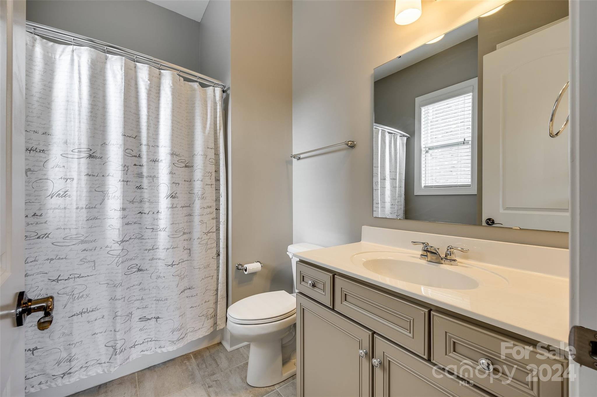 2264 Watermark Point Place Fort Mill, SC 29708 - Photo 14 of 48 a bathroom with a sink a toilet a mirror and shower