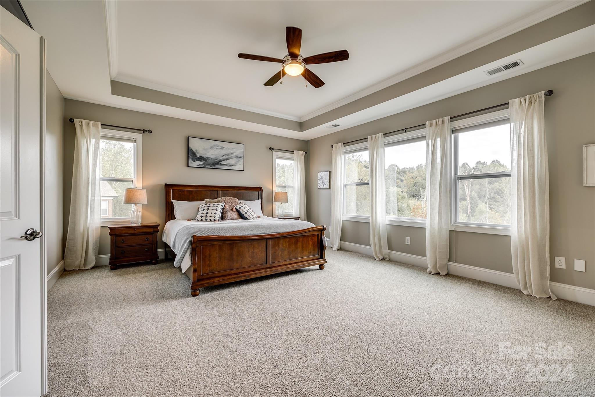 2264 Watermark Point Place Fort Mill, SC 29708 - Photo 18 of 48 a spacious bedroom with a bed and a ceiling fan